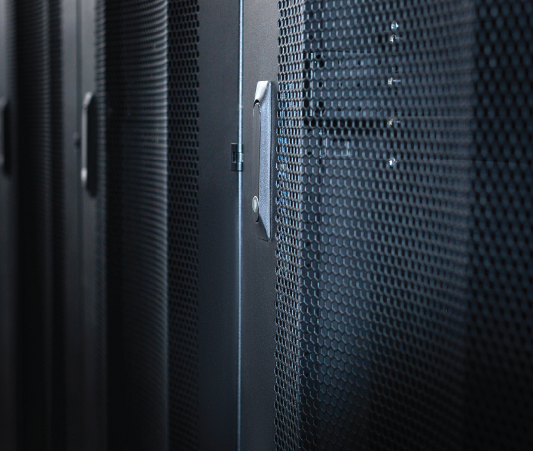 Data center with multiple rows of fully operational server racks.