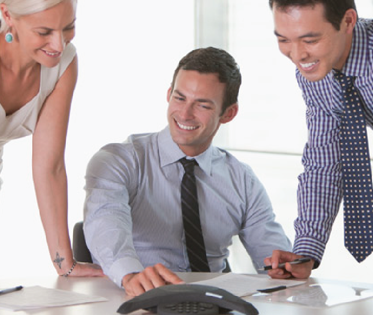 Three people working in an office. 